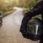 Rider holding motorcycle helmet